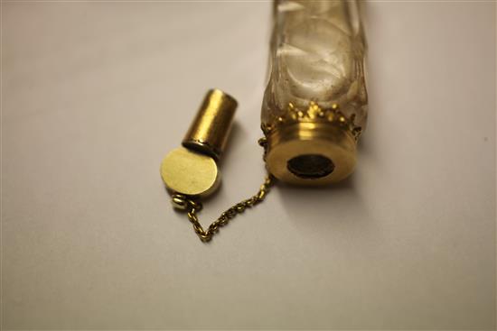 A cased late 18th century gold mounted cut glass miniature scent bottle with stopper and safety chain, approx. 2in.